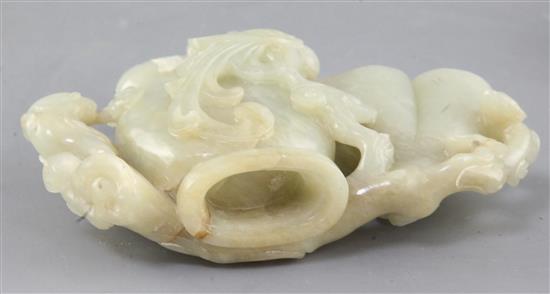 A Chinese pale celadon jade phoenix vessel, 18th / 19th century, 10.5 x 14.5cm, original carved wood stand, slight faults